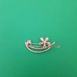 گیره دخترانه مدل گل نگین دار رنگ طلایی